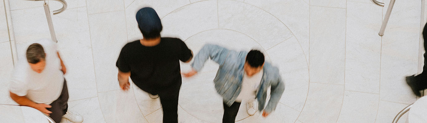 View from above of two people walking past each other